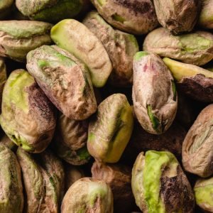 Pistachos sin cascara mostrando su color verde y marron caracteristico